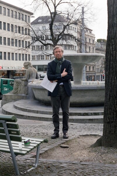 Portrait von Dr. Dieter Schwarz. Er steht vor einem Brunnen.