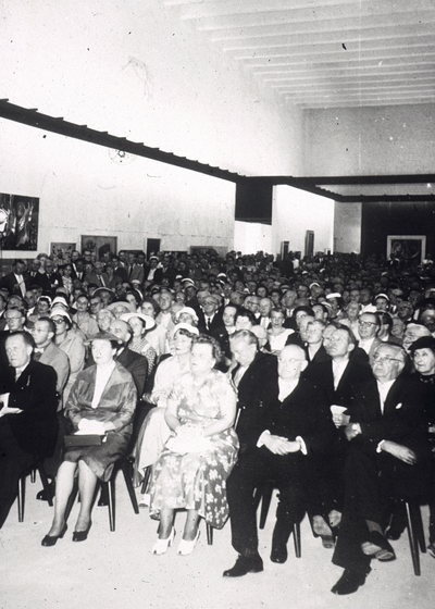 Historic black and white photo: audience at the opening speech in a packed hall