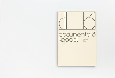 Cover aus dem Ausstellungskatalog der documenta 6 mit typografischer Gestaltung und der Aufschrift ‚documenta 6 kassel – fotografie film video‘ auf hellem Hintergrund.