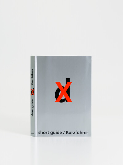 Frontal view of the short guide, silver cover with a black "d" in the middle, with a red cross above it