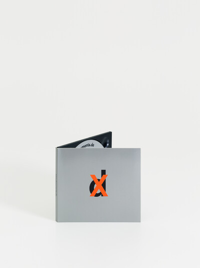 View of the CD, upright and unfolded so that part of the inside is visible.